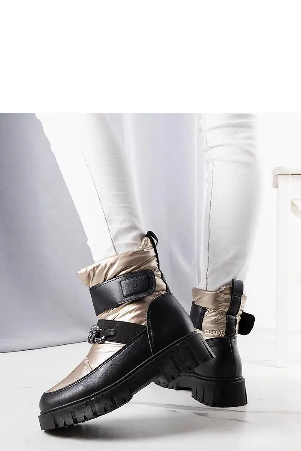 Golden snow boots with a chain